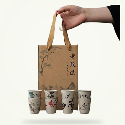 Rustic ceramic tea cups boxed set of 6 on plain background, raw clay earth tones