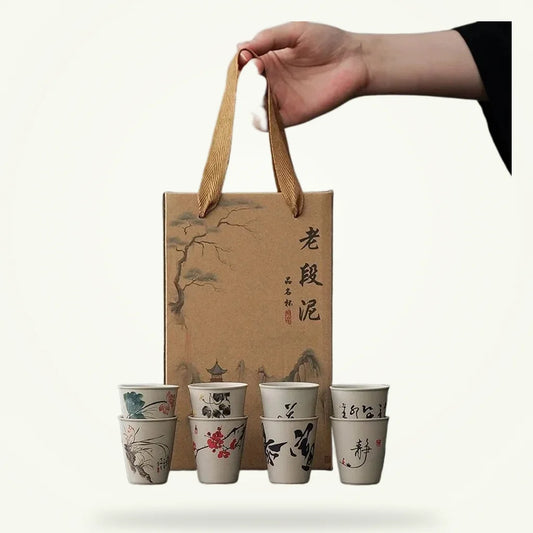 Rustic ceramic tea cups boxed set of 6 on plain background, raw clay earth tones
