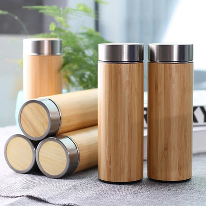 Scandinavian bamboo teapot 450ml pouring hot tea with steam rising from spout
