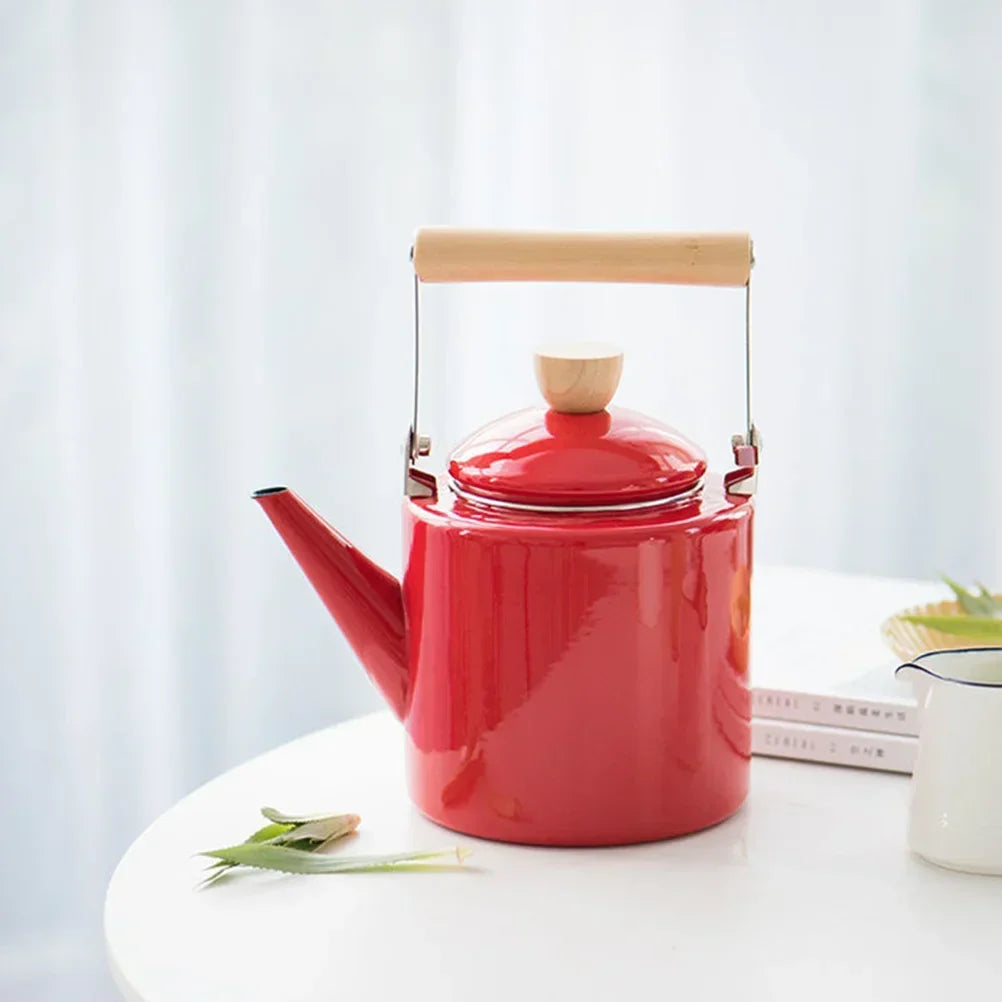 White Scandinavian teapot pouring tea into a ceramic cup