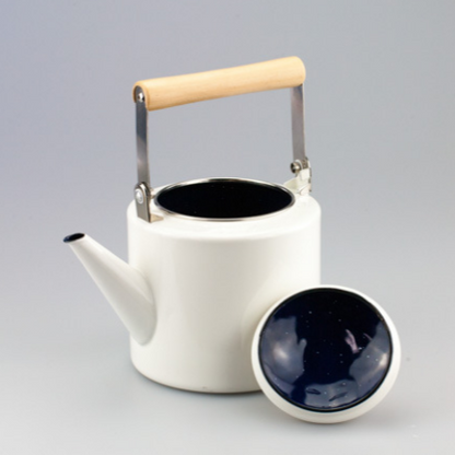 Side view of Scandinavian stoneware teapot showing handle shape