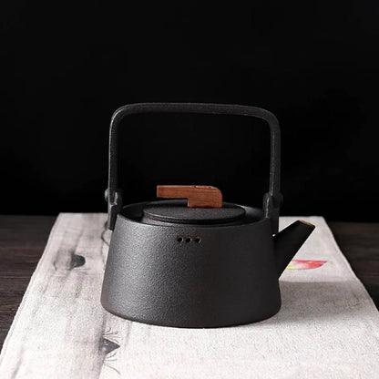 Nordic ceramic teapot lid open showing stainless steel infuser inside