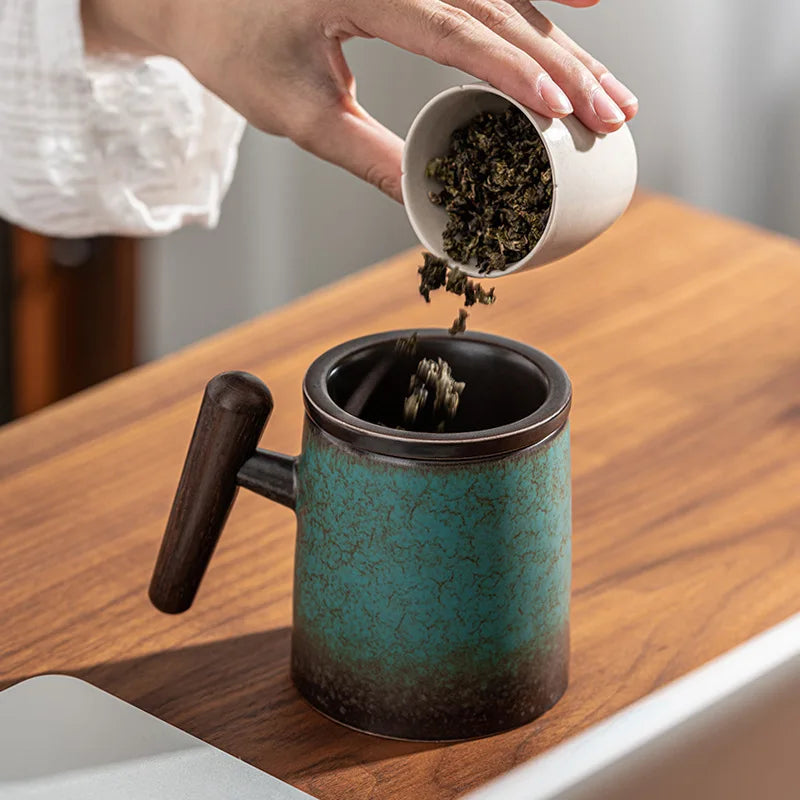 Pouring loose leaf tea from Scandinavian ceramic teapot into a mug