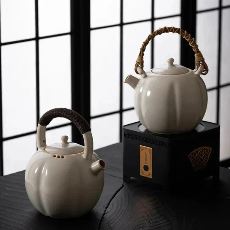 Scandinavian ceramic teapot pouring loose leaf tea into cup, cozy kitchen setting