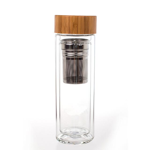 Side view of minimalist glass teapot showing bamboo lid and double wall construction