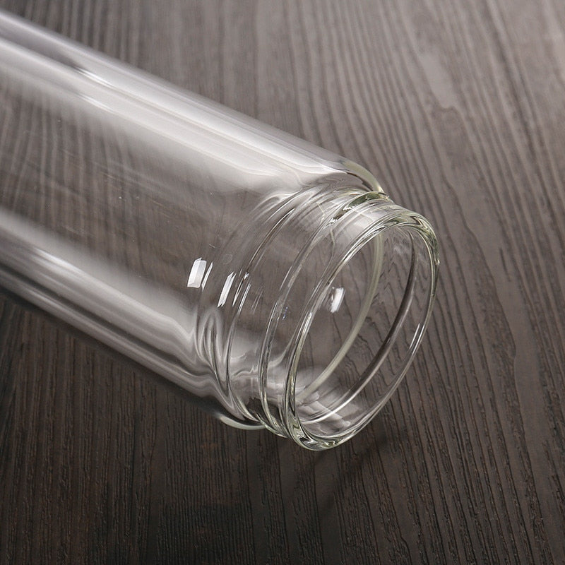 Studio shot of minimalist borosilicate glass teapot with bamboo lid, full side view