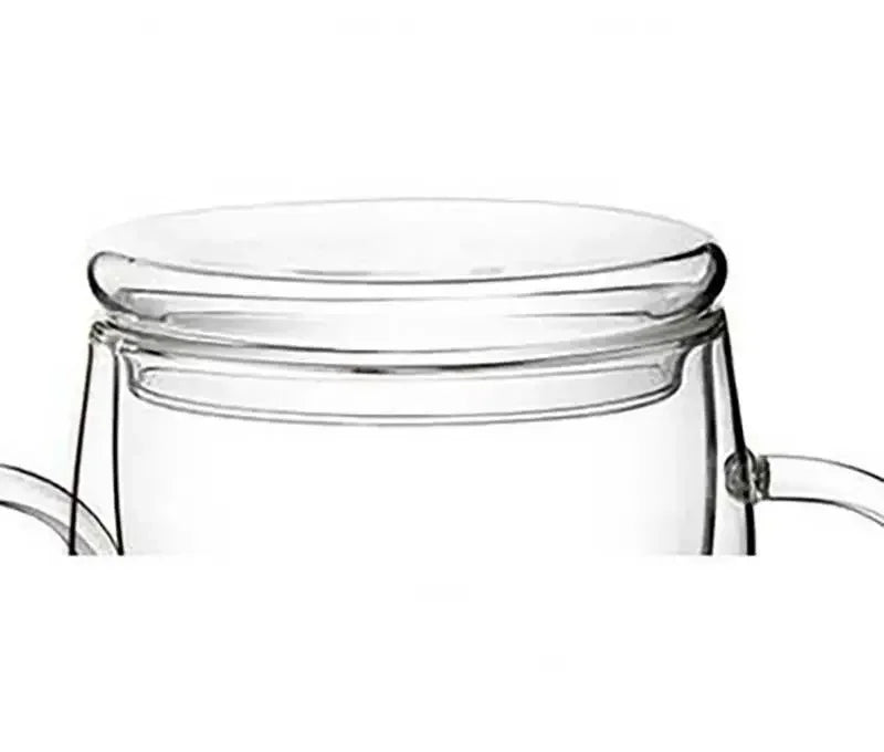 Double wall glass teapot with bamboo lid pouring hot tea, insulated grip