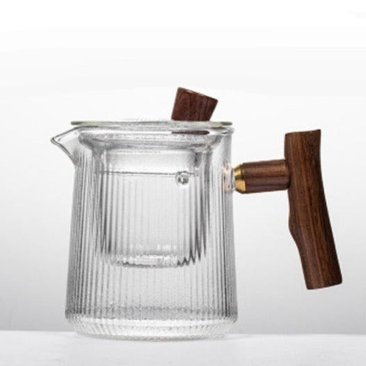 Scandinavian glass teapot on wooden tray with two small cups