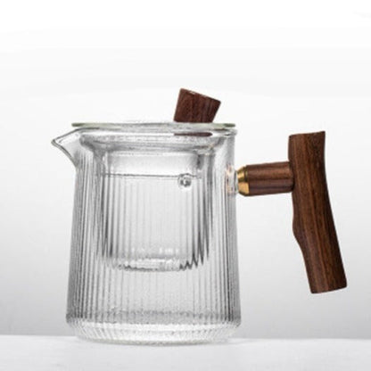 Scandinavian glass teapot on wooden tray with two small cups