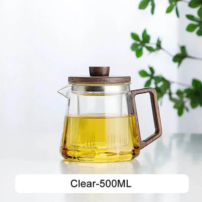 Glass teapot with matching cup and saucer, full tea service setup