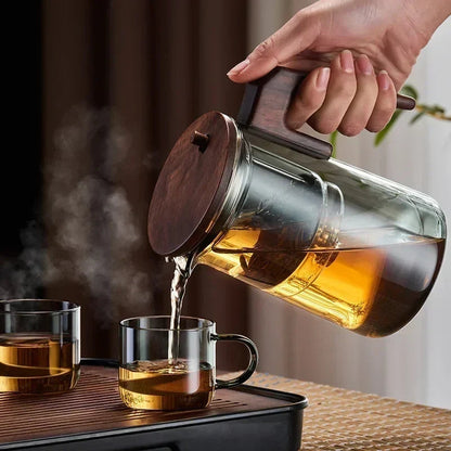 Borosilicate glass teapot with loose-leaf infuser on wooden table