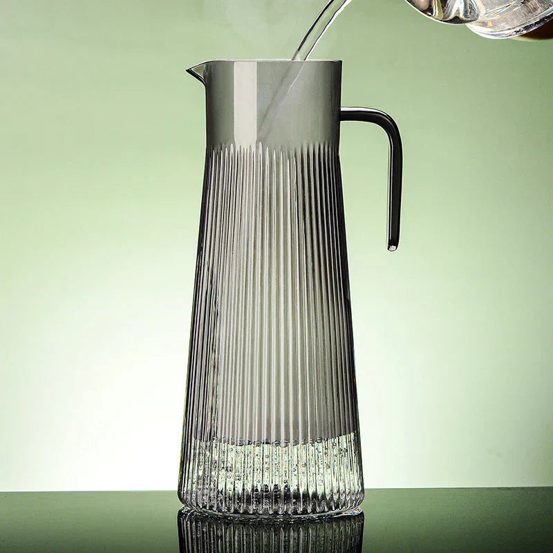 Glass teapot with tea cup and saucer