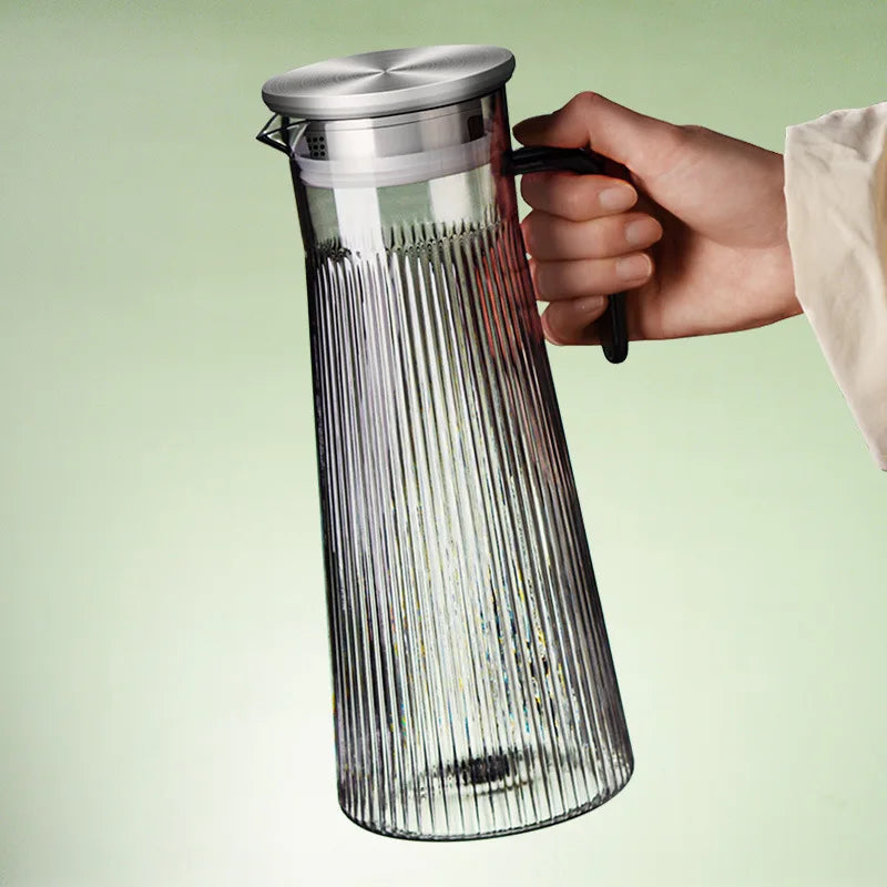 Large glass teapot with loose tea leaves steeping inside infuser