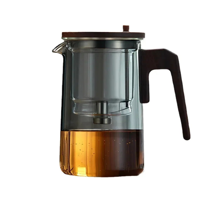 Close-up of removable stainless steel infuser inside glass teapot