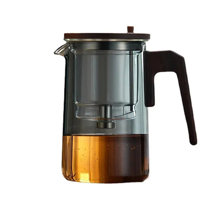 Close-up of removable stainless steel infuser inside glass teapot