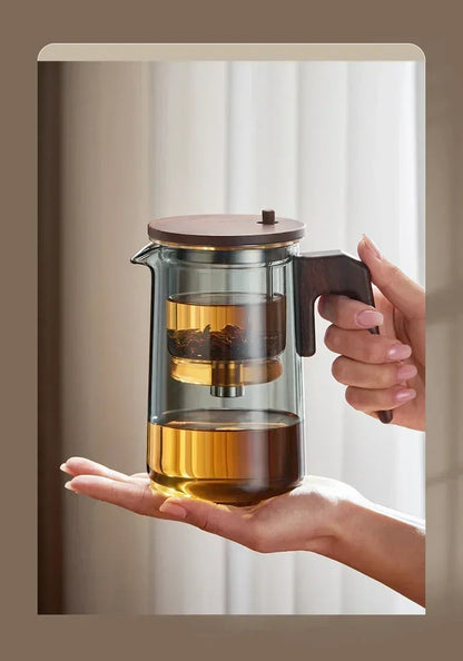 Glass teapot lid detail and matching glass warmer for loose-leaf brewing