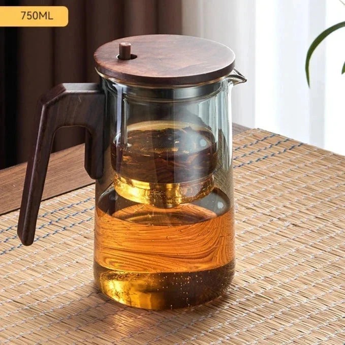 Close-up of clear glass teapot body showing tea color during steeping