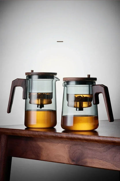 Transparent borosilicate glass teapot showing brewed tea color through clear body