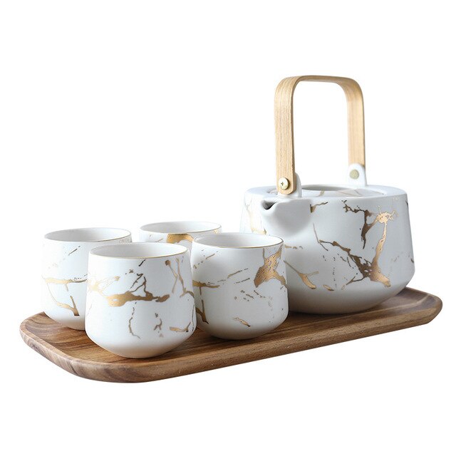 Scandinavian porcelain teapot 1L in Black and Gold, full view on pale surface