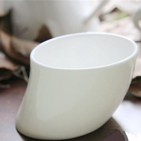 Elegant porcelain teapot with cups close up