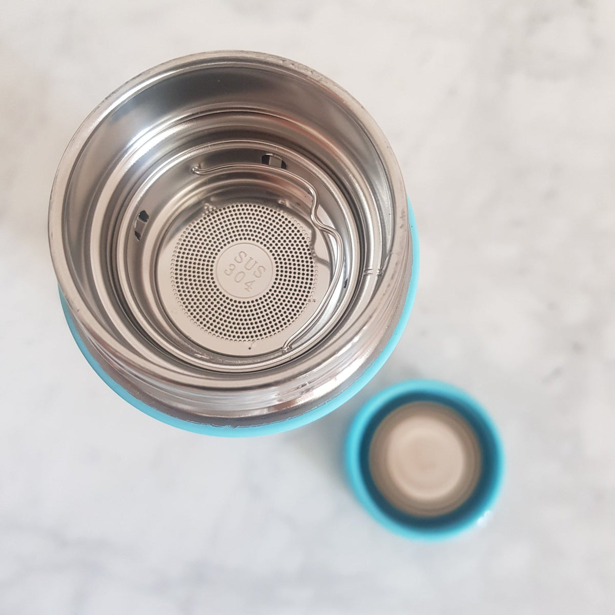 Brushed steel finish Scandinavian teapot with infuser side profile close-up