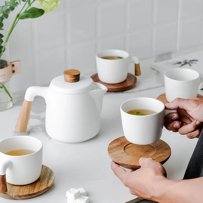 Scandinavian teapot paired with matching black ceramic cup and saucer