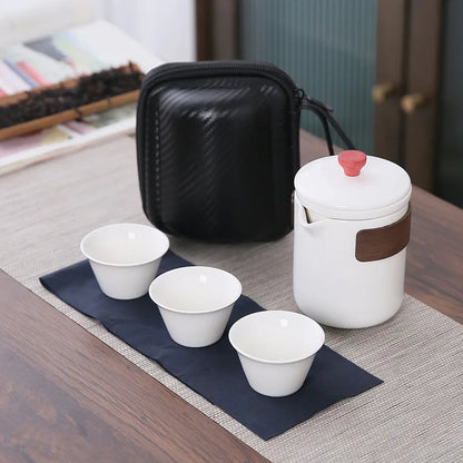 Scandinavian ceramic teapot pouring tea into a small cup