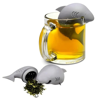 Shark silicone tea infuser clipped onto a white ceramic mug