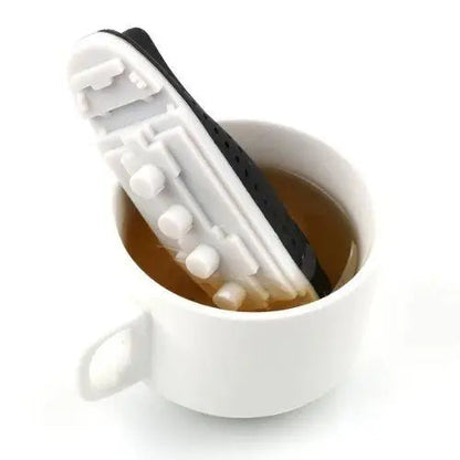 Boat tea infuser floating in a cup of tea