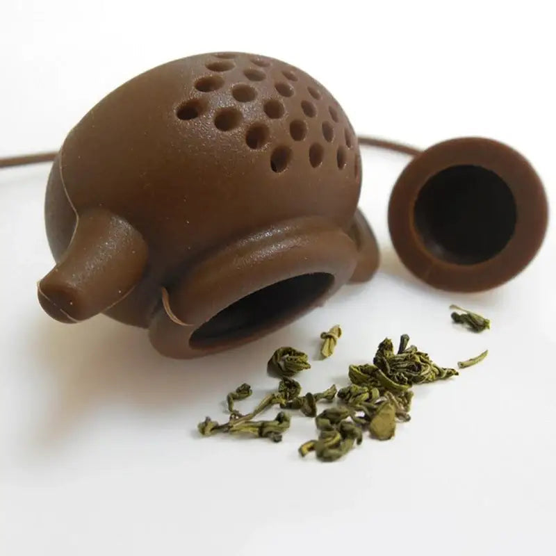 Silicone tea infuser in teapot shape with tea leaves