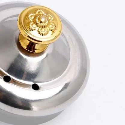 Close-up of oriental stainless steel teapot lid engraved detail