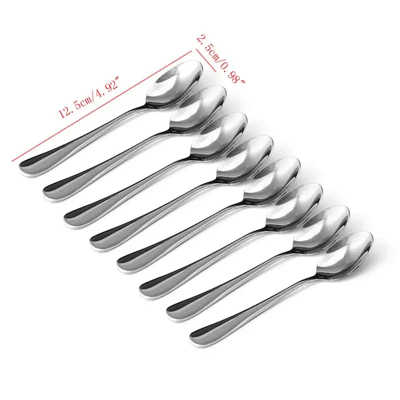 Silver tea spoons arranged with a teapot and cup
