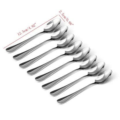 Silver tea spoons with a cozy tea setting