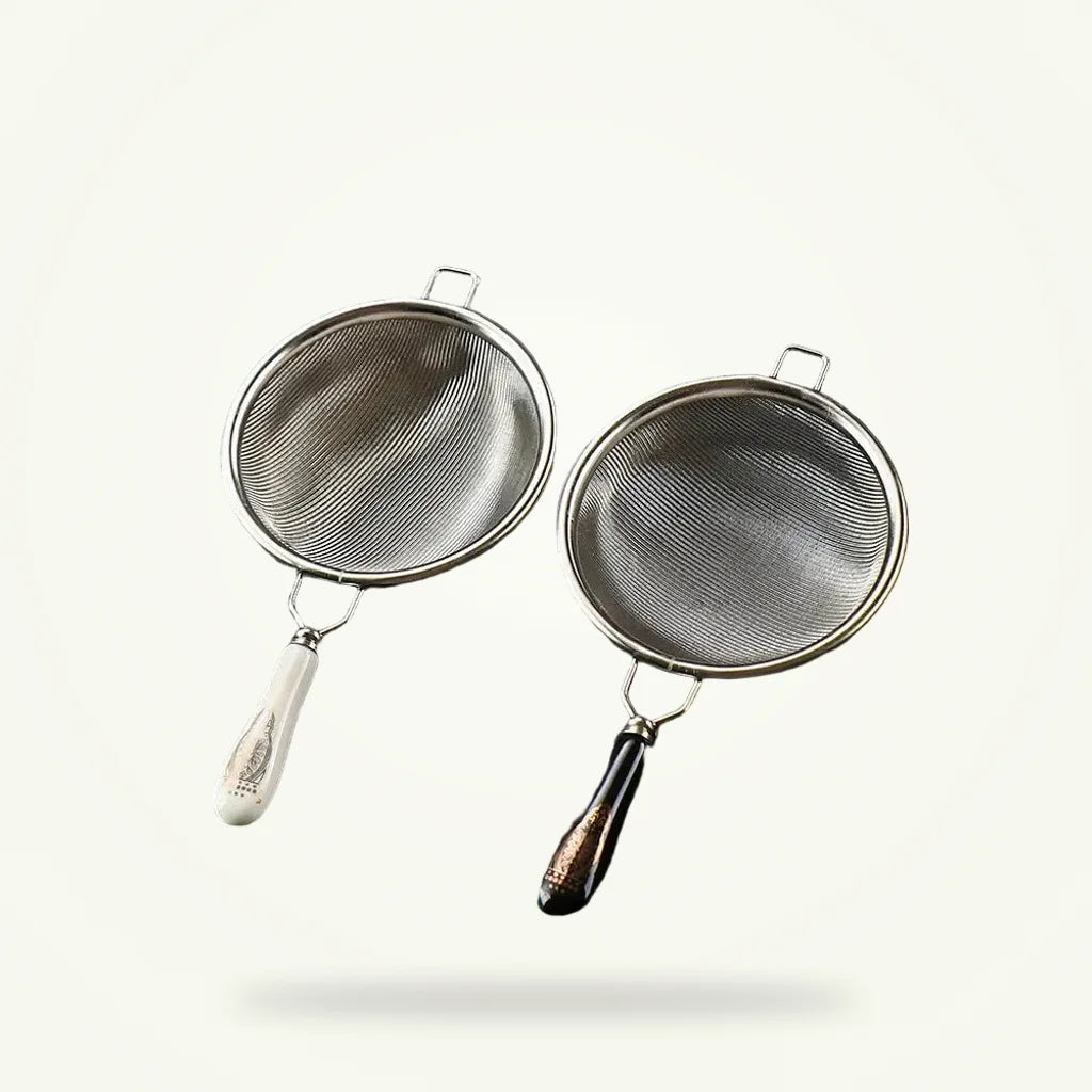 Silver stainless steel tea strainer by Granny Lulu on plain background
