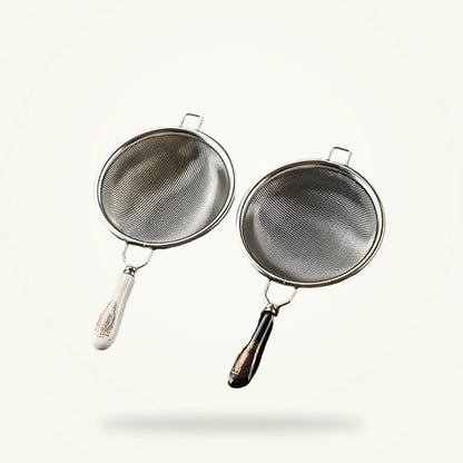 Silver stainless steel tea strainer by Granny Lulu on plain background