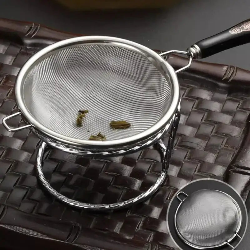 Side view of silver tea strainer showing handle and mesh depth