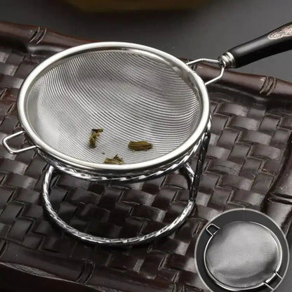 Side view of silver tea strainer showing handle and mesh depth