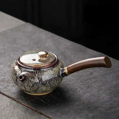 Gray small ceramic teapot with steam rising