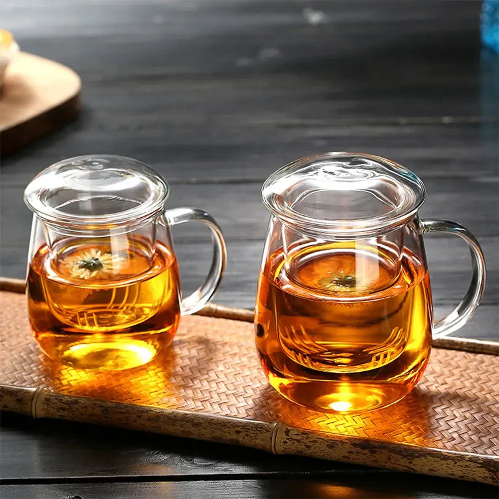 Small glass teapot with infuser on wooden table