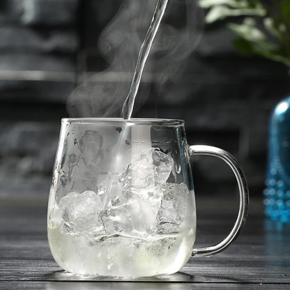 Glass teapot with infuser and tea cup side view