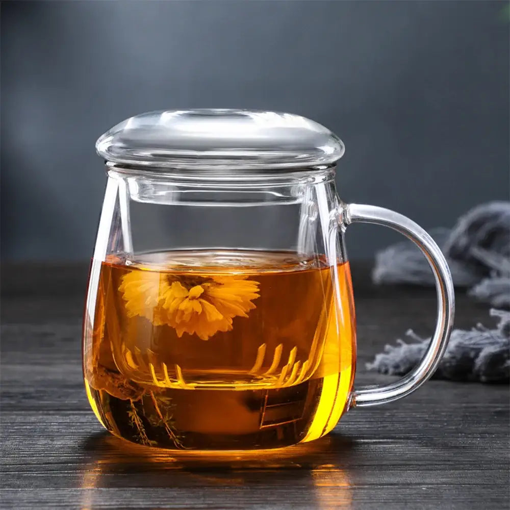 Teapot and cup set on tray with tea leaves