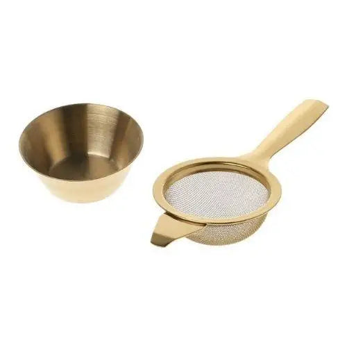 Small stainless steel tea strainer in gold finish on white background