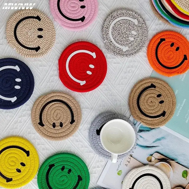 Smiley coaster set in assorted colors on a table