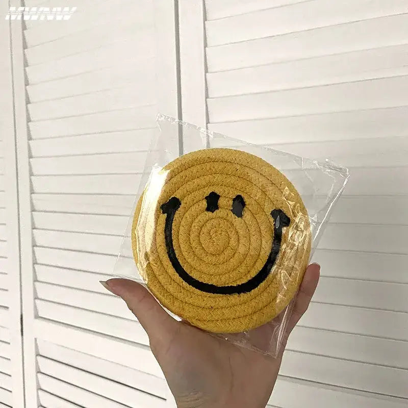 Smiley coasters in a row on a shelf