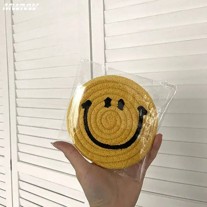 Smiley coasters in a row on a shelf