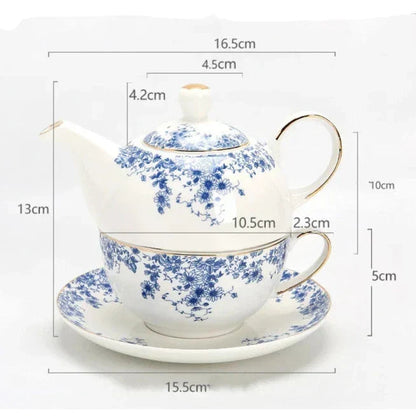 Porcelain teapot for one with cup and saucer side angle