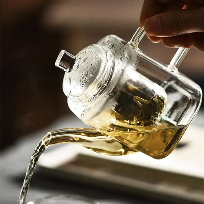 Square glass teapot with glass lid and flat handle, top angle