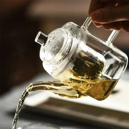 Square glass teapot with glass lid and flat handle, top angle