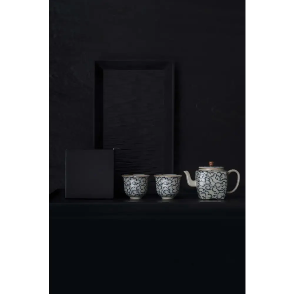 Square porcelain teapot with steam rising from spout