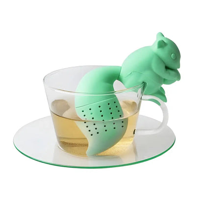 Squirrel silicone tea infuser hooked over rim of mug